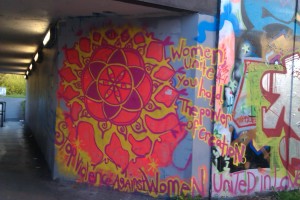Colourful piece of graffiti that says 'Stop Violence Against Women' 