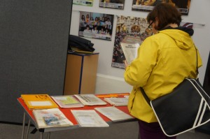 An attendee reads the archive material displayed at the event